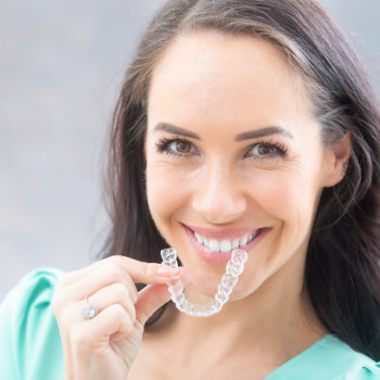 attractive woman holding using invisible braces
