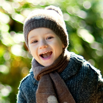 laughing boy in a winter hat
