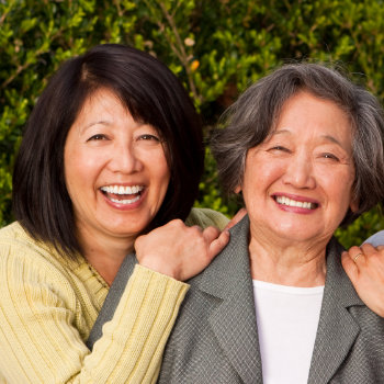 mature asian mother with daughter laughing